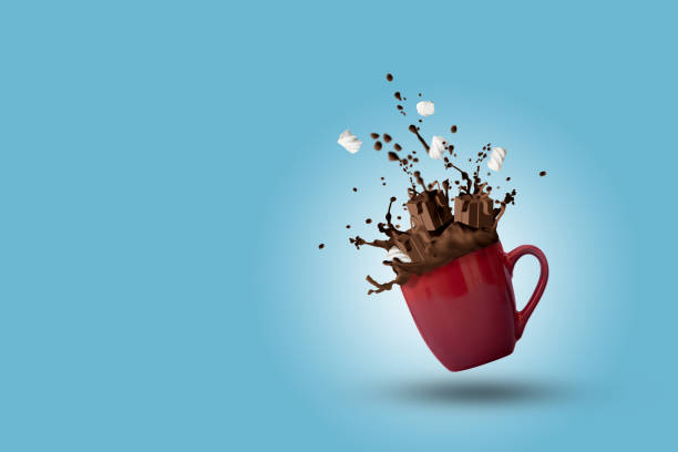 istock Cup of splashing hot chocolate with marshmallows as gift boxes shape on blue background. Christmas and New Year holidays concept. Copy space 1188412024