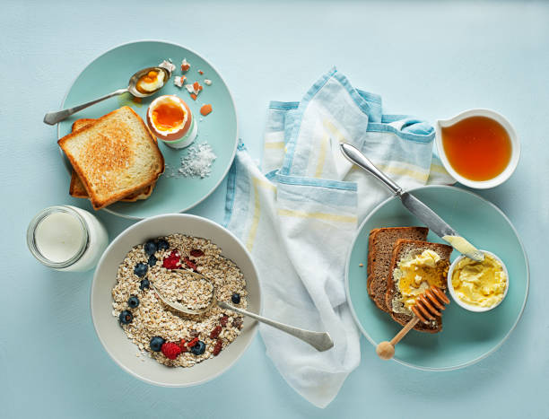 istock Breakfast table with oatmeal and fruits, boiled egg, honey and butter 1188413071