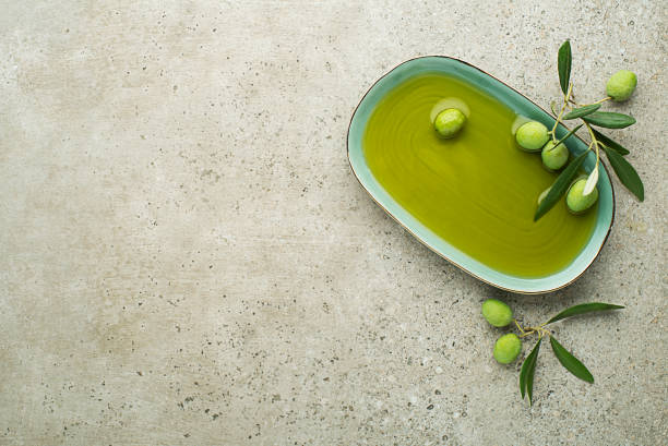 istock Olive oil background with olives and leaves 1188413099