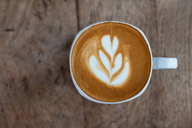 istock Latte art coffee on wooden table 1188413177