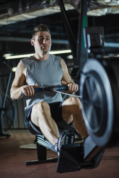 istock Athletic man doing rowing exercises at the gym 1188413278