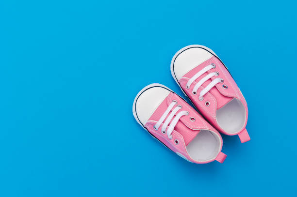 Directly Above Shot Of Baby Booties Against Blue Background  baby booties stock pictures, royalty-free photos & images