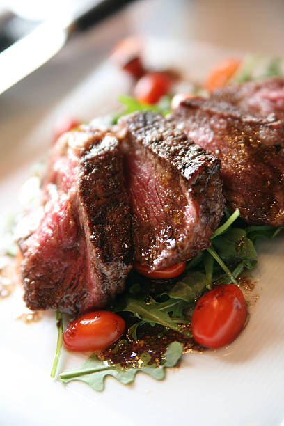 Grilled New York Strip on a bed of Arugula stock photo