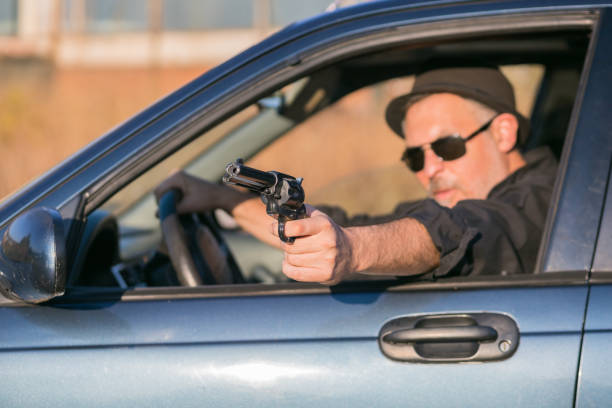 istock criminal in car with gun replica in hand 1188417291