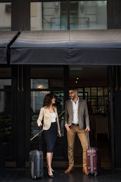 istock Young couple with suitcase at hotel door 1188421326