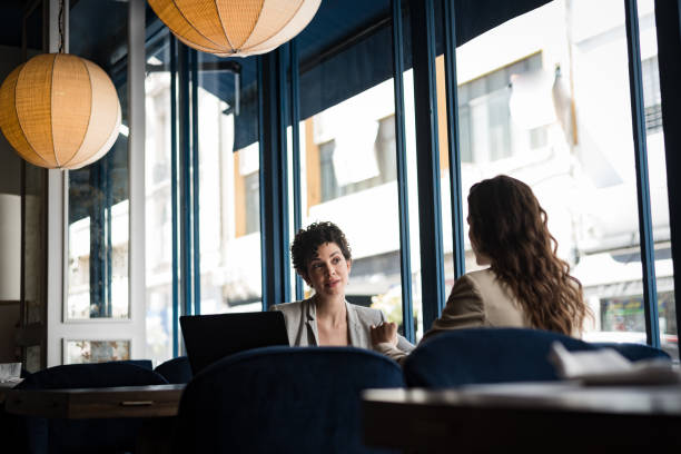 istock Two women with computer in meeting at a cafe 1188422405