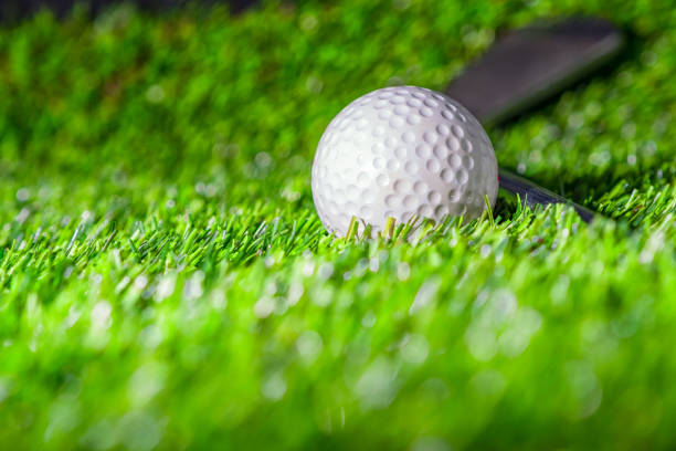 istock Golf ball with golf club on green grass 1188422641
