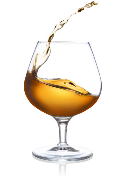 istock glass of splashing cognac on white background 1188423729
