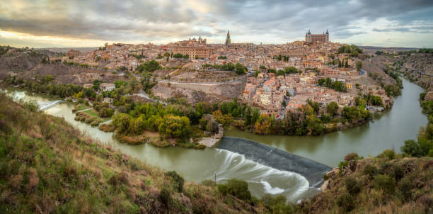 long exposure Panoramic image of Toledo city at sunset long exposure Panoramic image of Toledo city at sunset, Spain el alcazar palace seville stock pictures, royalty-free photos & images