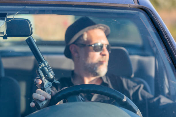 istock mobster in car waiting for a crime 1188425189