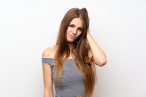 Young woman with long hair over isolated white wall with an expression of frustration and not understanding