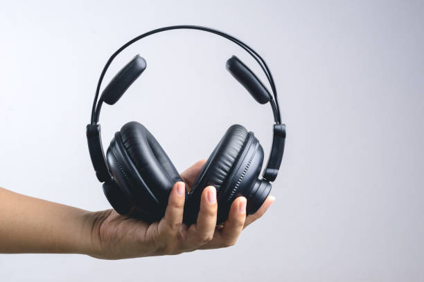 istock Hand holding full ear or studio headphone 1188426528