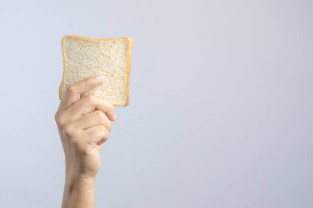 istock Hand holding sliced whole grain bread 1188427677