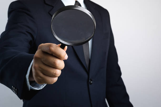 istock Business man hand holding magnifier for inspection 1188428239