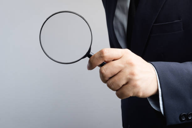 istock Business man hand holding magnifier for inspection 1188429262