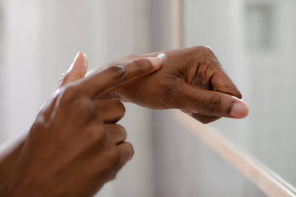 istock Woman Applying Moisturizing Cream on her Hand 1188429381