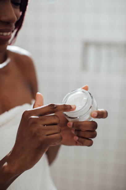 istock A Woman Standing in the Bathroom and Using Cosmetics 1188429389