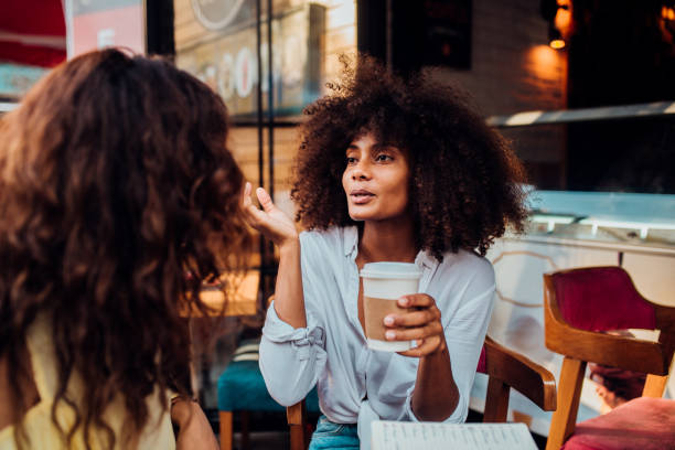istock Two friends drinking coffee and gossiping 1188430776