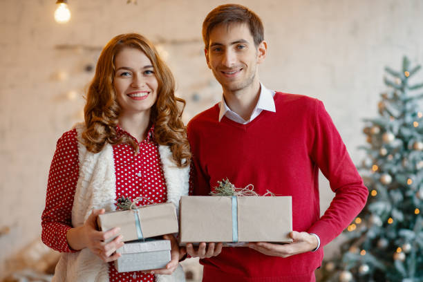 istock Happy young couple with Christmas presents 1188433235