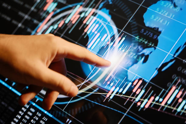 istock Businessman is pointing on a hi technology futuristic digital screen with financial analytics 1188433370