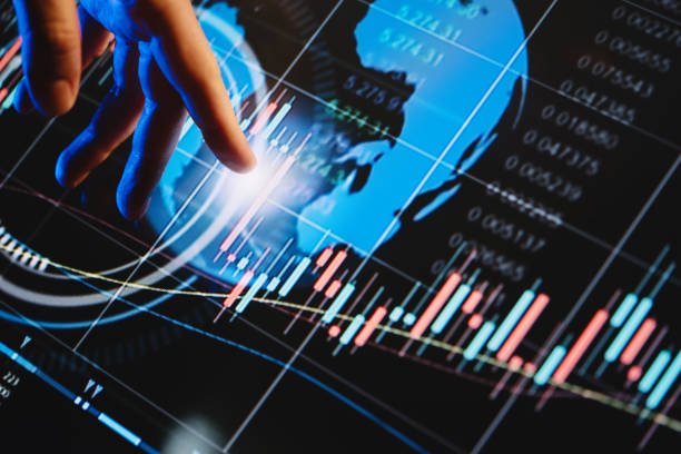 istock Businessman is pointing on a hi technology futuristic digital screen with financial analytics 1188433376