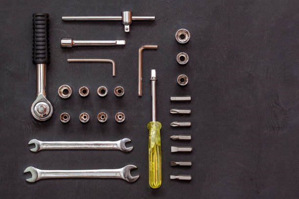 istock Tools for work. Wrench, socket wrench, spanner on black background. Repair auto concept. Flat lay composition. Top view 1188433534
