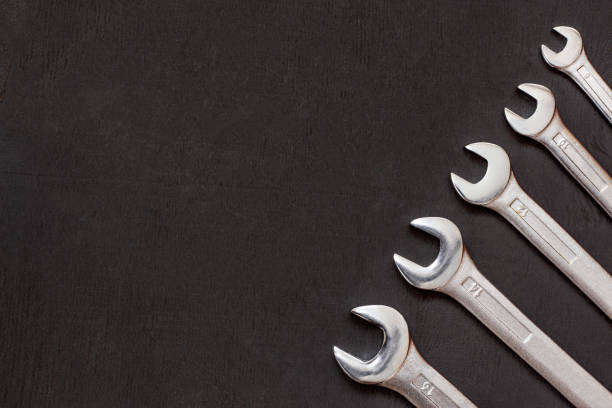 istock Wrenches, spanners. Set of wrench tool equipment. Different sizes on black with copy space. Industrial background. 1188433535