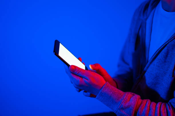istock Male hands with smartphone. Blank white screen. Mock-up. Neon light 1188434921