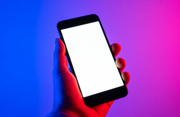 istock Male hands with smartphone. Blank white screen. Mock-up. Neon light 1188434929