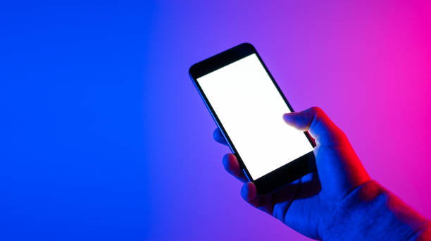 istock Male hands with smartphone. Empty white screen. Mock-up. Neon light 1188434931