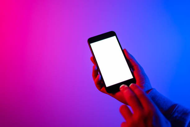 istock Male hands with smartphone. Blank white screen. Mock-up. Neon light 1188434933