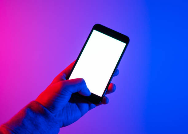 istock Male hands with smartphone. Blank white screen. Mock-up. Neon light 1188434940