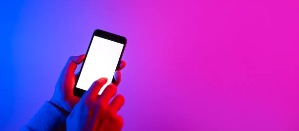 istock Male hands with smartphone. Blank white screen. Mock-up. Neon light 1188434945