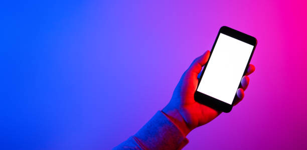 istock Male hands with smartphone. Blank white screen. Mock-up. Neon light 1188434946