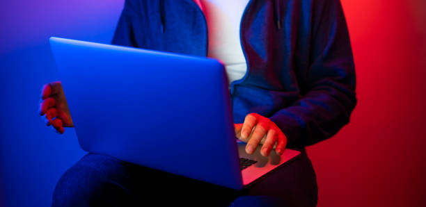 istock Young man with laptop. Neon light 1188434959