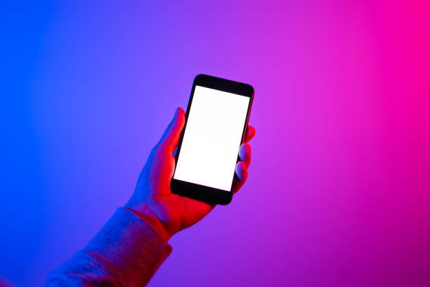 istock Male hands with smartphone. Empty white screen. Mock-up. Neon light 1188434960