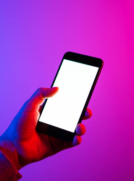 istock Male hands with smartphone. Blank white screen. Mock-up. Neon light 1188434971