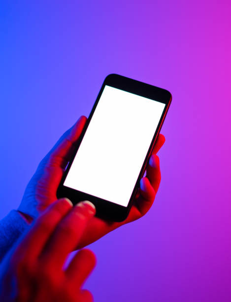 istock Male hands with smartphone. Empty white screen. Mock-up. Neon light 1188434975