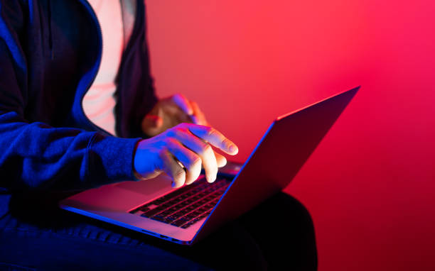 istock Young man with laptop. Neon light 1188434976