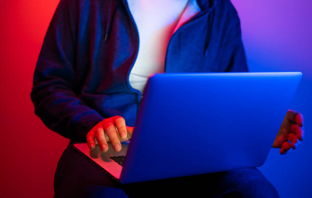 istock Young man with laptop. Neon light 1188434977
