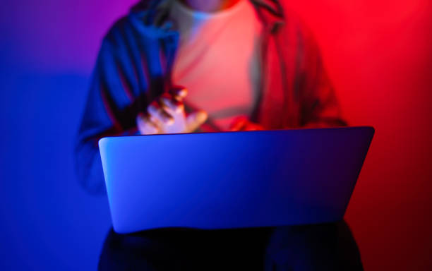 istock Young man with laptop. Neon light 1188434982