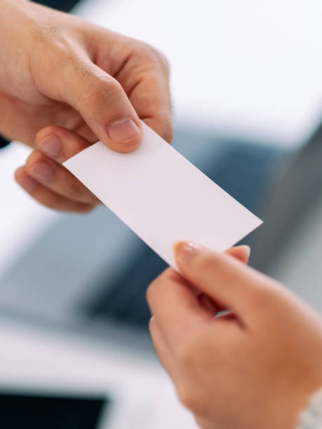 istock Two businessman holding and giving empty business card 1188435198