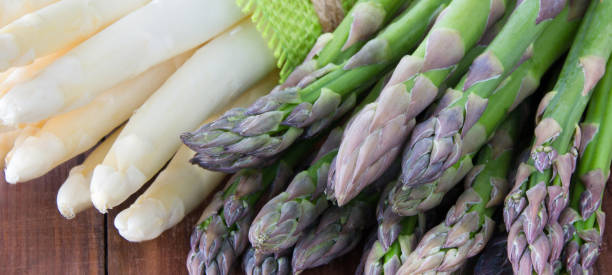 istock Green and white asparagus on a wood background 1188435436