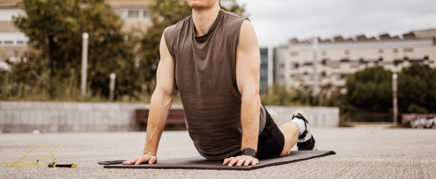 istock Young athletic man doing workout. Fitness outdoors. Stretching. Urban background. 1188436556