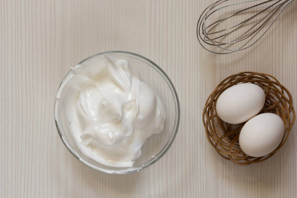 istock Whipped egg whites in glass bowl. Top view 1188438289