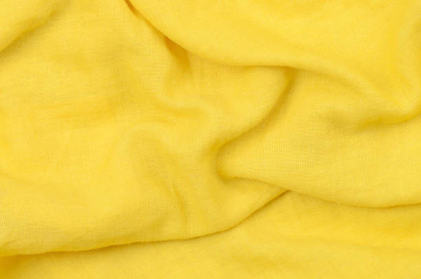 istock close up crumpled yellow cotton fabric background 1188439970