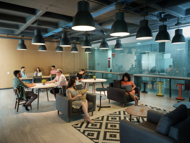 istock Latin people talking and using electronic devices in coworking space 1188440059