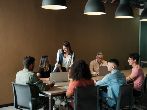 istock Two young women smiling at each other during team meeting 1188440103