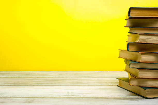 istock Open book, hardback books on wooden table. Back to school. Copy space 1188441470