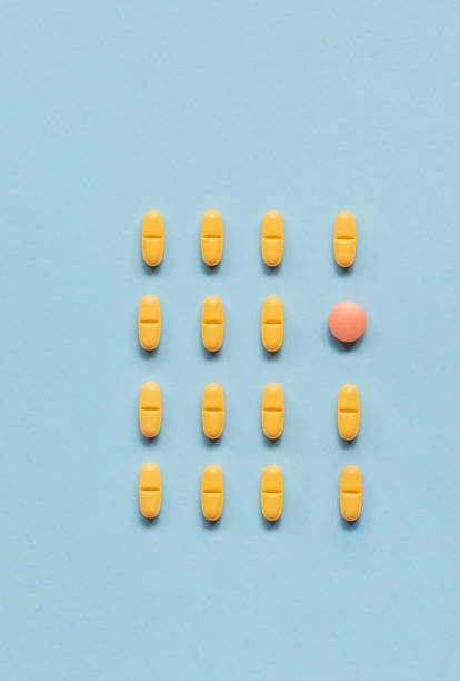 istock Yellow Pills on Soft Blue Background 1188441717